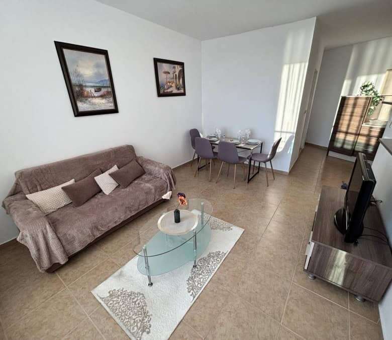Sea view 1-bedroom apartment in Costa Calma, Ravda, with modern furnishings and spacious living area.