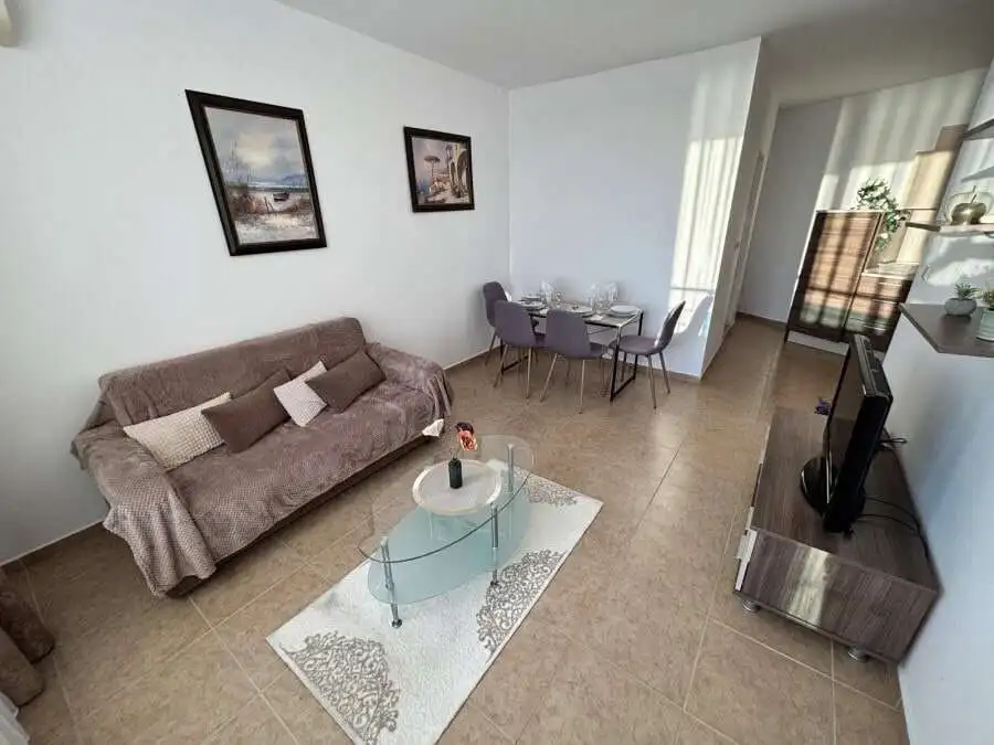 Sea view 1-bedroom apartment in Costa Calma, Ravda, with modern furnishings and spacious living area.