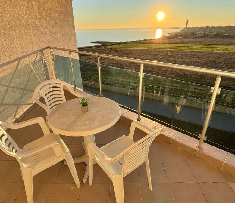 Sea view balcony with sunset over the coast in Ravda, Bulgaria.