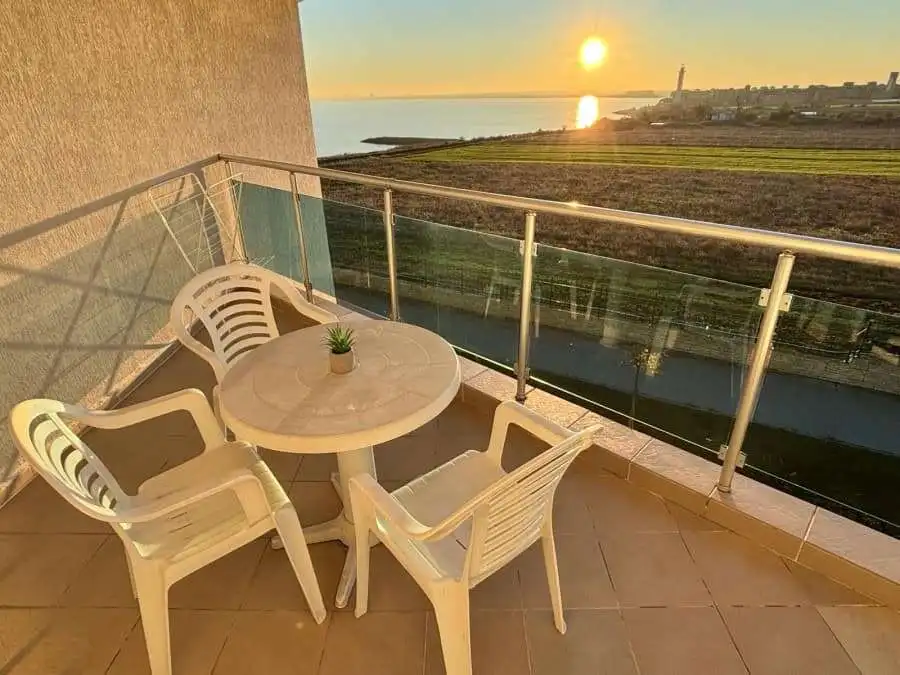 Sea view balcony with sunset over the coast in Ravda, Bulgaria.