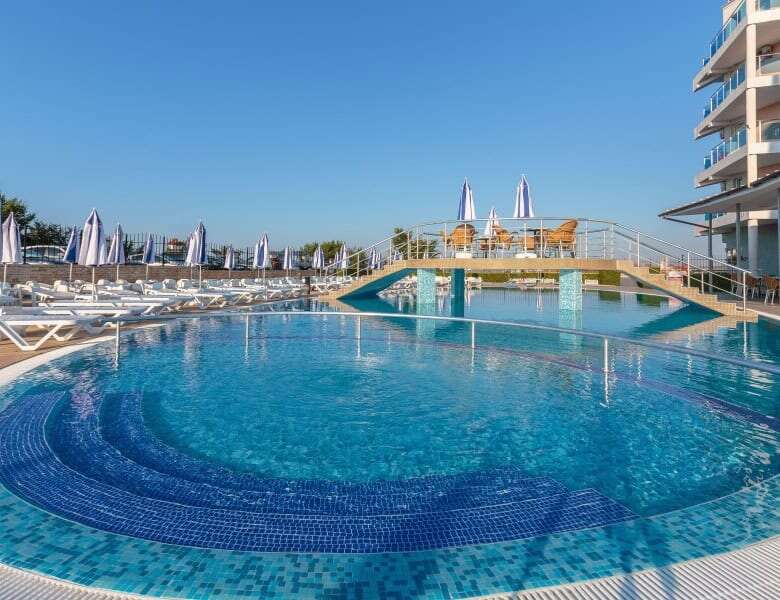Sea view pool with sun loungers and umbrellas in Costa Calma, Ravda.