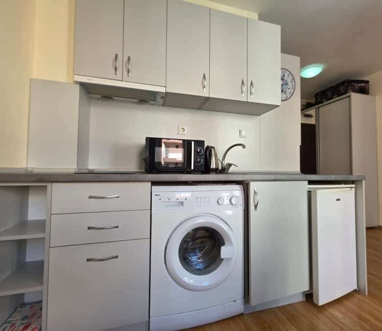 Compact kitchen with washing machine and microwave near Nessebar.