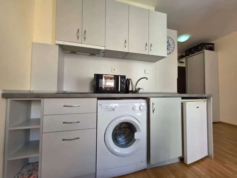Compact kitchen with washing machine and microwave near Nessebar.