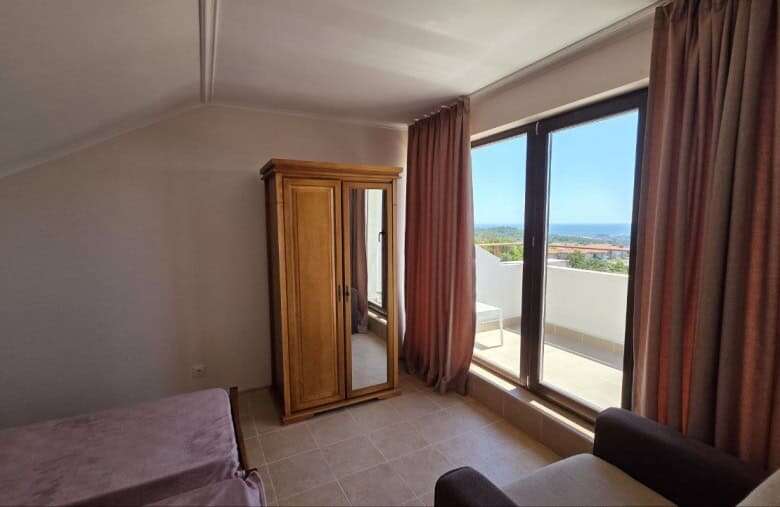 Sea view bedroom in Bulgaria with balcony and natural light.
