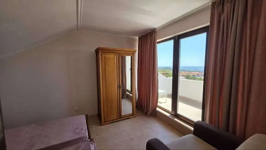 Sea view bedroom in Bulgaria with balcony and natural light.