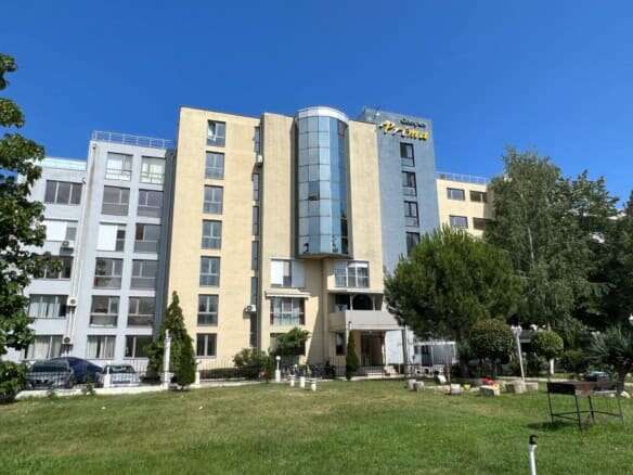 Modern apartment building in Sunny Beach with Prime signage.