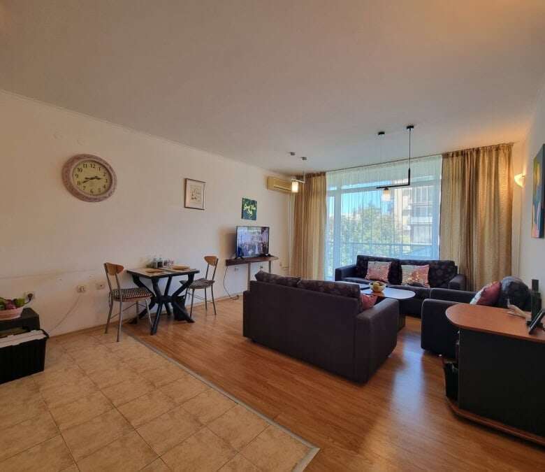 Comfortable living room with large windows and seating area in Prima 1, Sunny Beach.