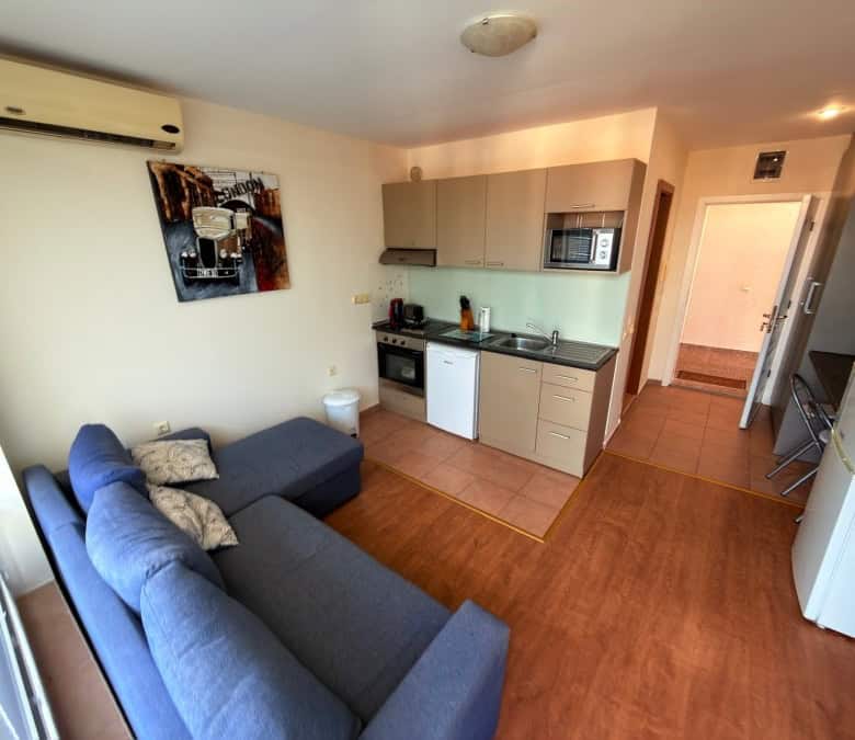 Comfortable living room with sofa and kitchen area in Nessebar Fort Club, Sunny Beach.