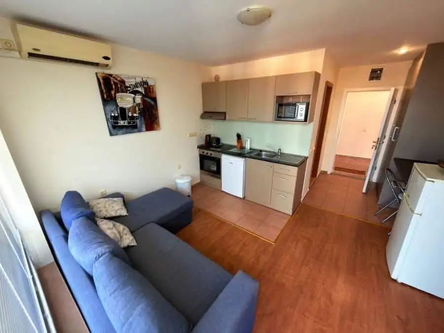 Comfortable living room with sofa and kitchen area in Nessebar Fort Club, Sunny Beach.