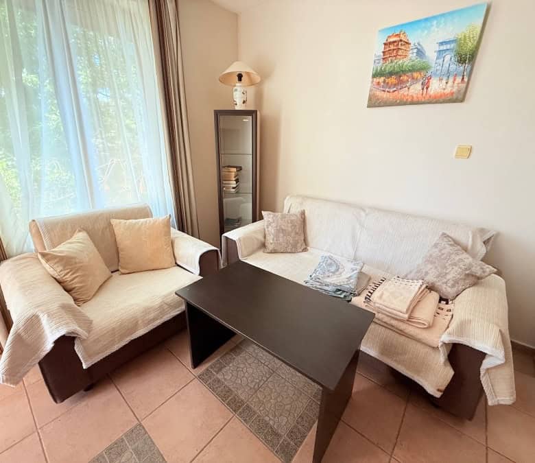 Bright living room with comfortable sofas and natural light in Sunny Beach.