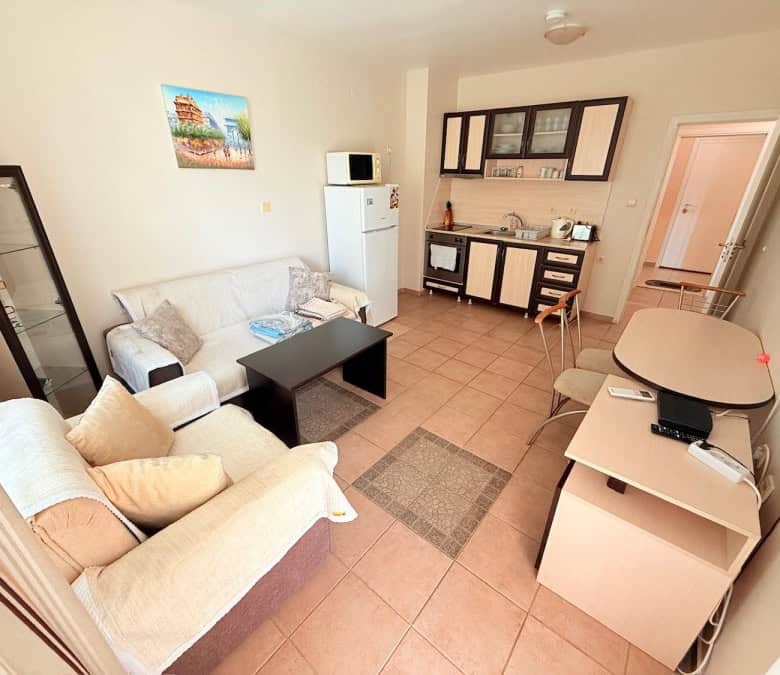 Bright living room with sofa and TV in Summer Dreams resort.