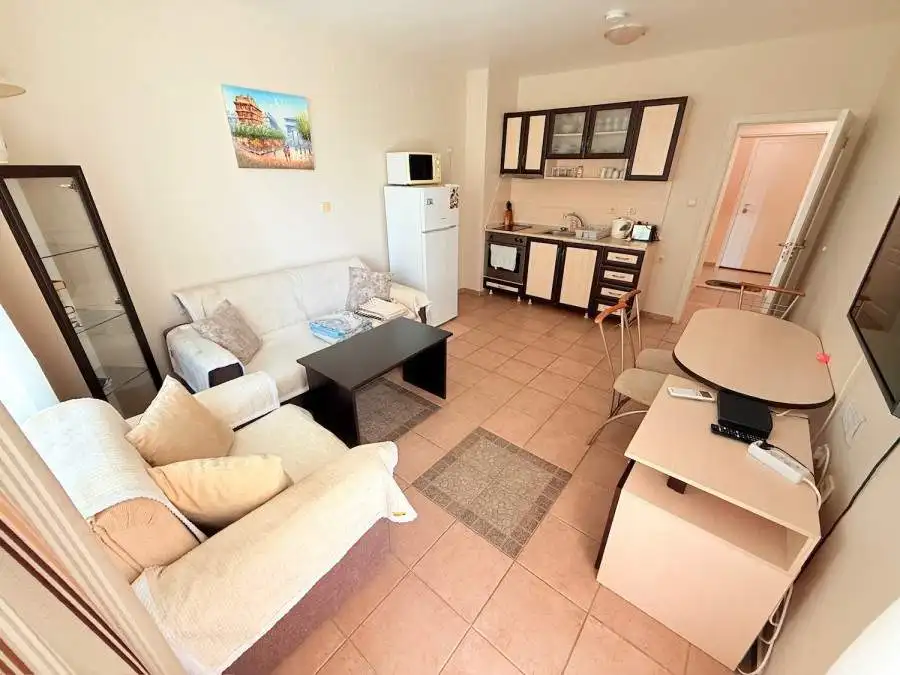 Bright living room with sofa and TV in Summer Dreams resort.