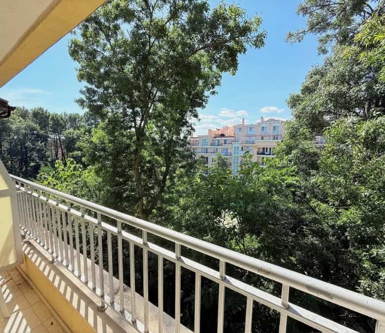 Balcony view of lush greenery and nearby buildings at Summer Dreams, Sunny Beach.