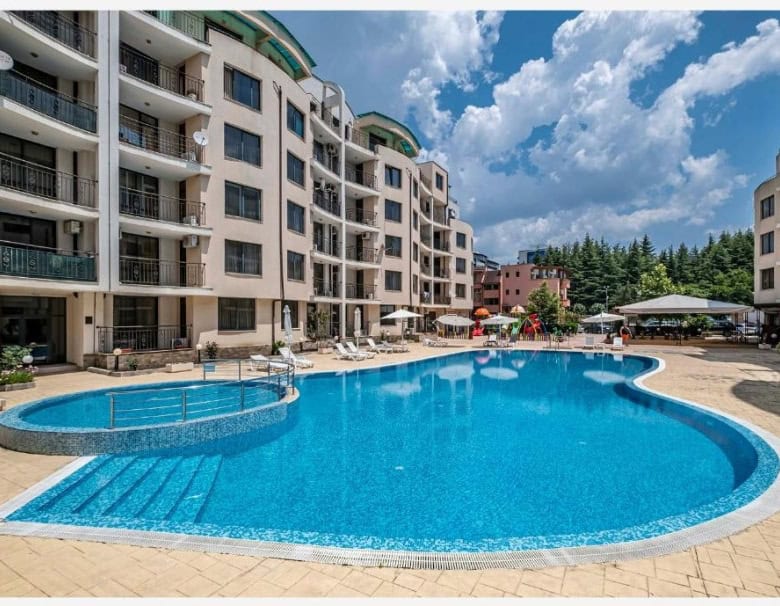 Bright outdoor swimming pool at Avalon Sunny Beach residential complex.