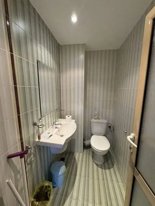 Bathroom with toilet, sink, and mirror in Avalon, Sunny Beach.