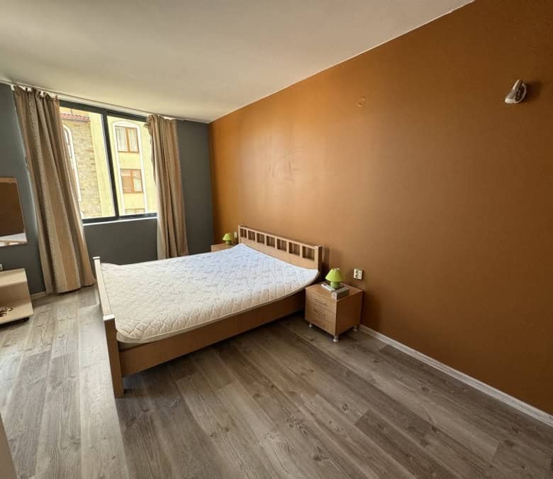 Spacious bedroom with large window, wooden flooring, and contemporary decor in Avalon, Sunny Beach.