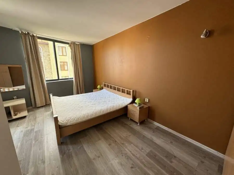 Spacious bedroom with large window, wooden flooring, and contemporary decor in Avalon, Sunny Beach.
