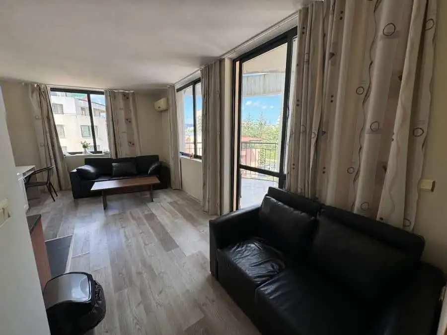 Bright living room with large windows and terrace in Avalon Sunny Beach apartment.