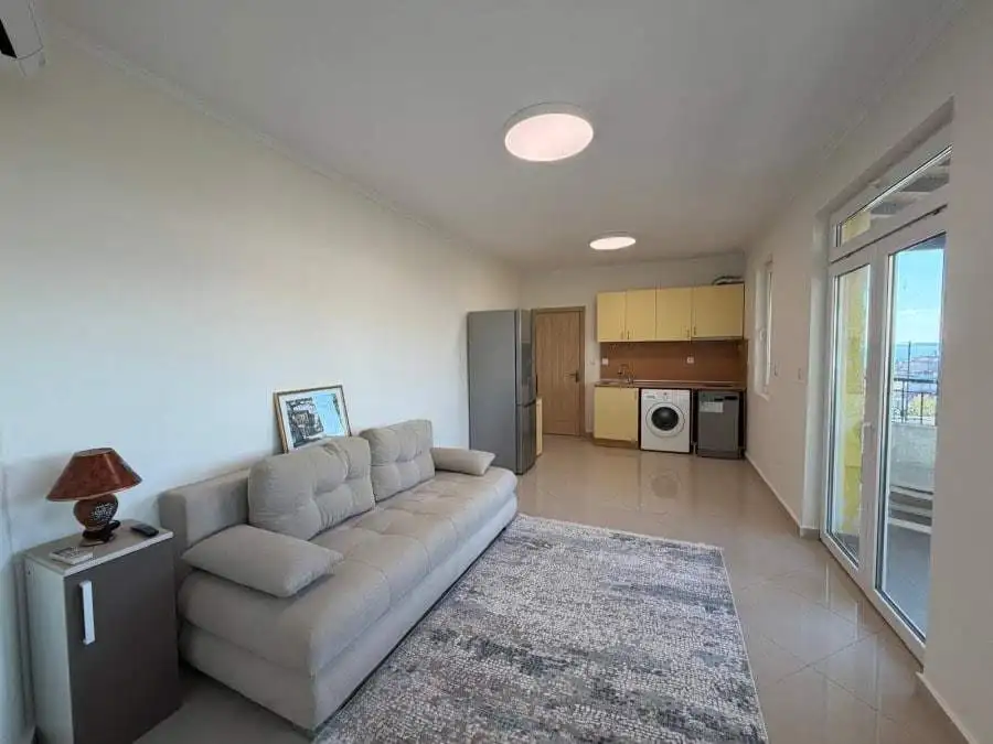 Bright 1-bedroom apartment in Sveti Vlas with sea views, open-plan living area, and balcony.