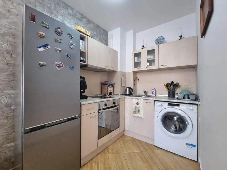 Modern kitchen with fridge, oven, washing machine, and appliances in Golden Dreams, Sunny Beach.