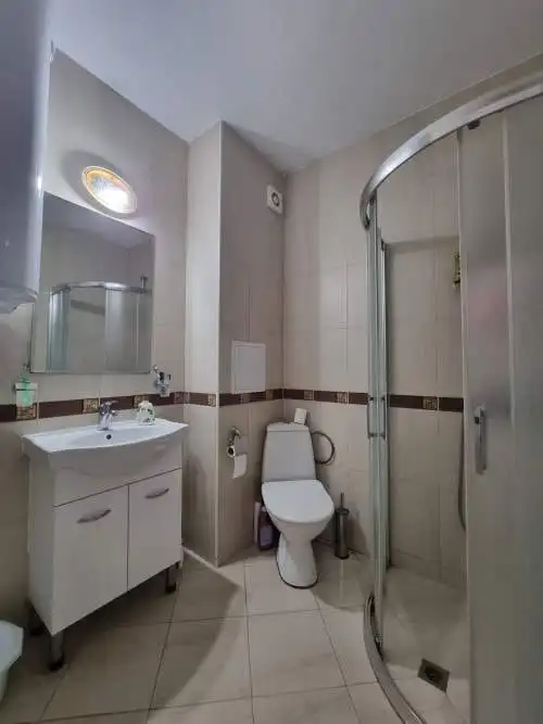 Bathroom with shower, toilet, and sink in modern apartment at Golden Dreams, Sunny Beach.