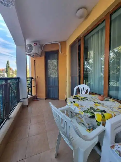 Balcony overlooking the pool at Golden Dreams, Sunny Beach, with outdoor dining setup.