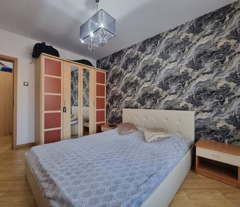 Apartment bedroom with pool view, modern decor, and stylish furnishings in Golden Dreams complex.
