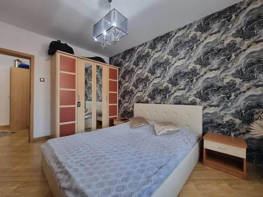 Apartment bedroom with pool view, modern decor, and stylish furnishings in Golden Dreams complex.