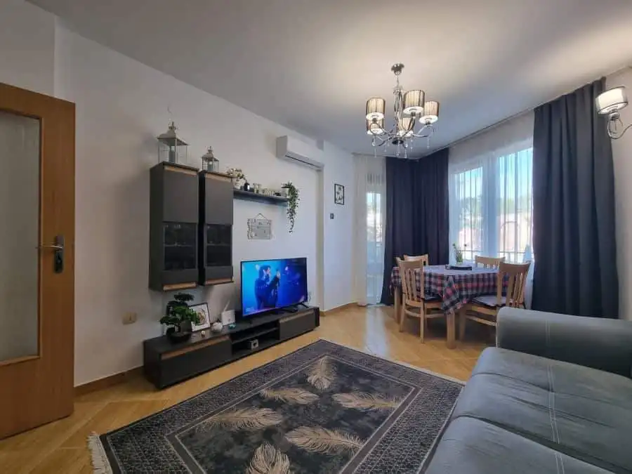 Bright living room with TV, dining table, and large windows in Golden Dreams, Sunny Beach.
