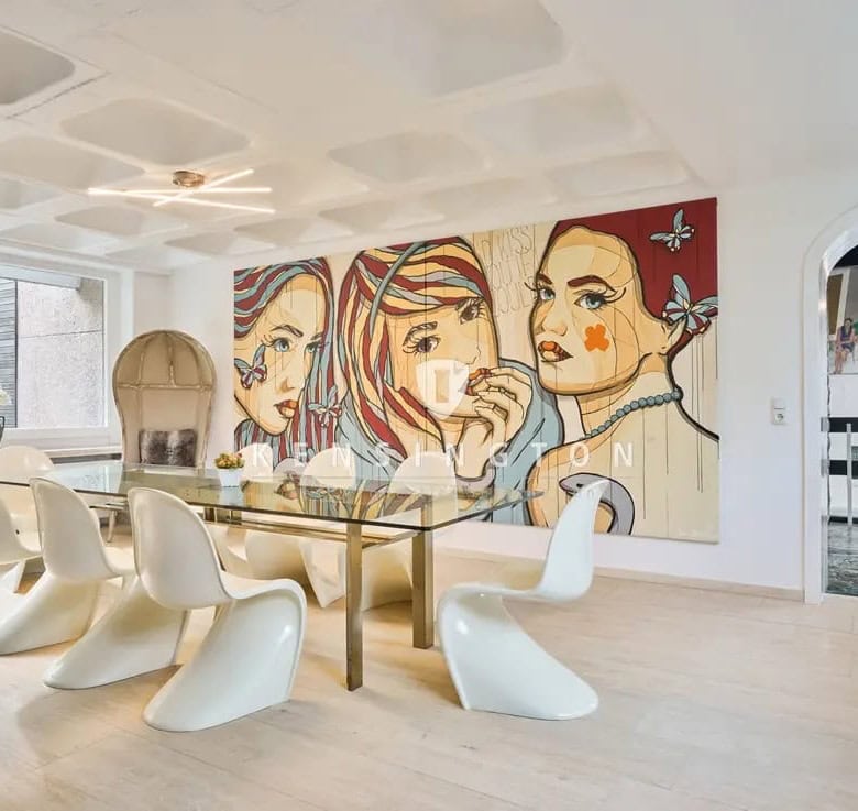 Elegant dining room with modern art mural and stylish white chairs.