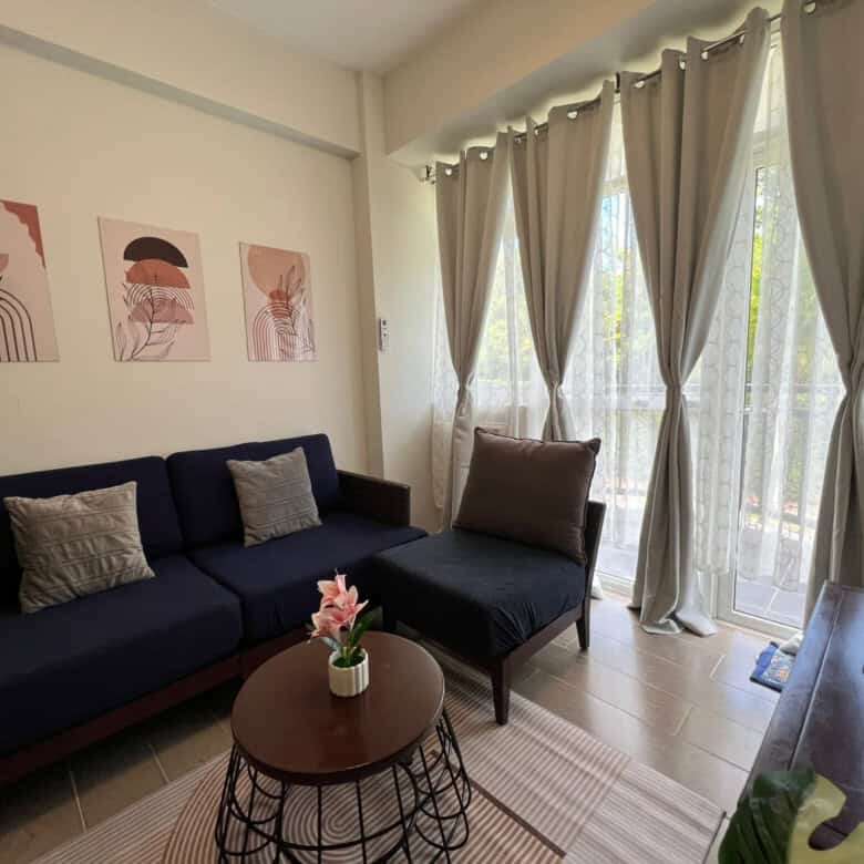 Spacious living room with natural light, stylish decor, and balcony views in Oceanway Residencies Bo.