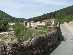 Beautiful view of a rural village in Olargues, Herault, with traditional houses and lush green hills.