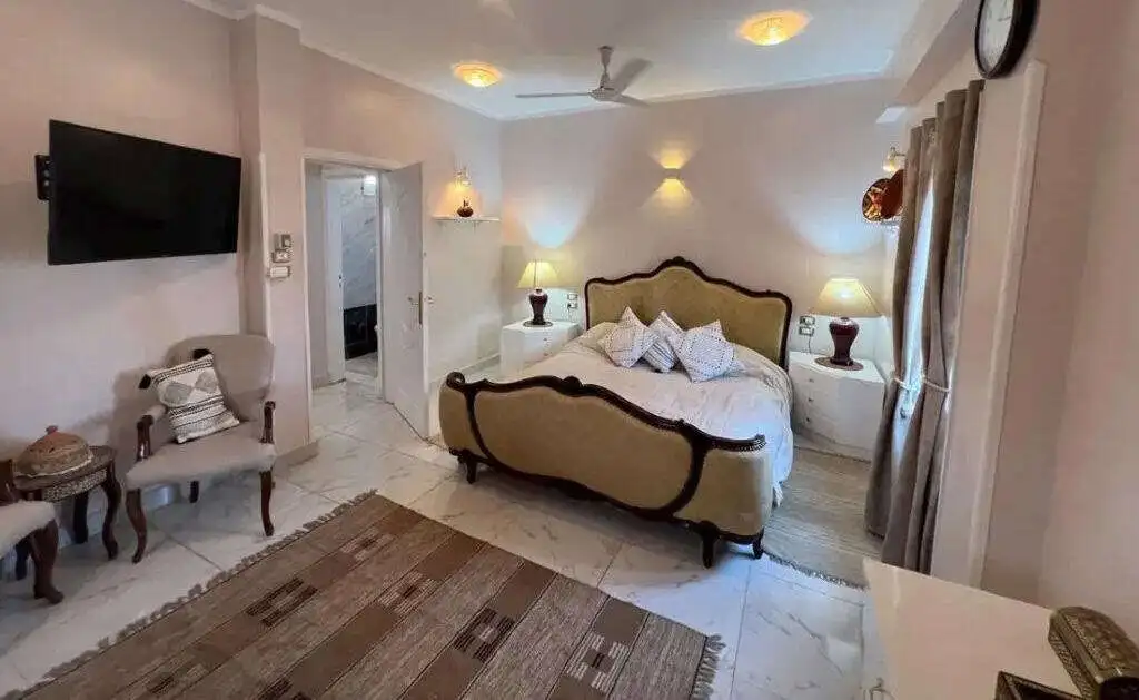 Elegant bedroom in Derrymore Glen estate, County Clare, with classic furnishings and cozy ambiance.