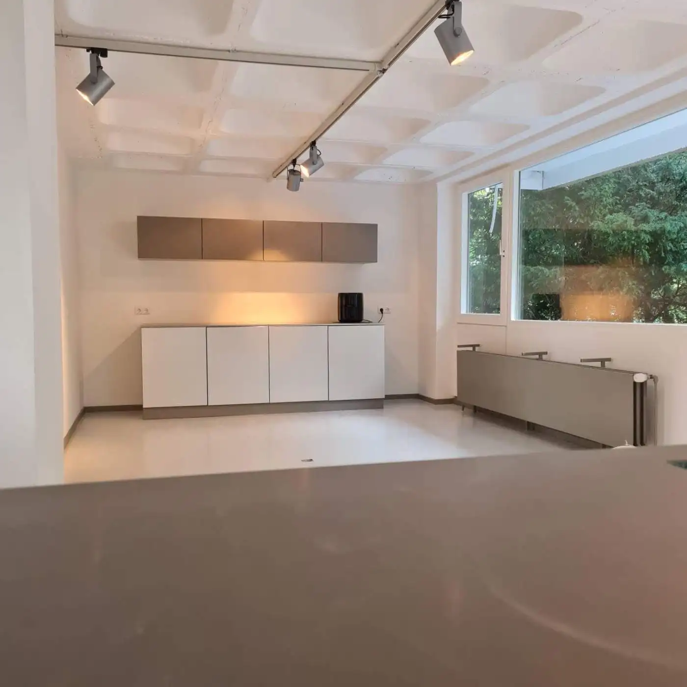 Villa interior with modern kitchen and large window views.
