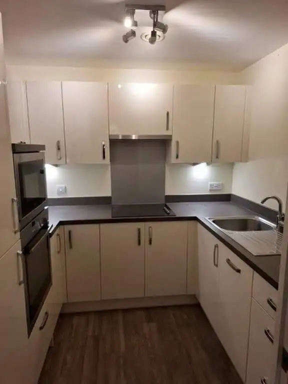 Bright 2-bedroom kitchen with contemporary cabinets and appliances in Hampshire property.