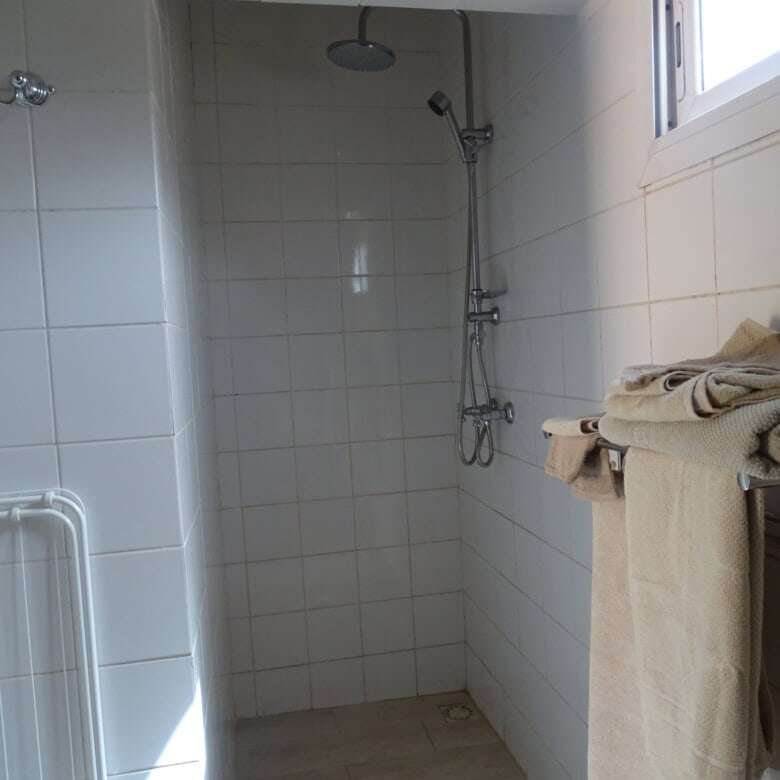 Modern bathroom with shower in Kombo North district property.