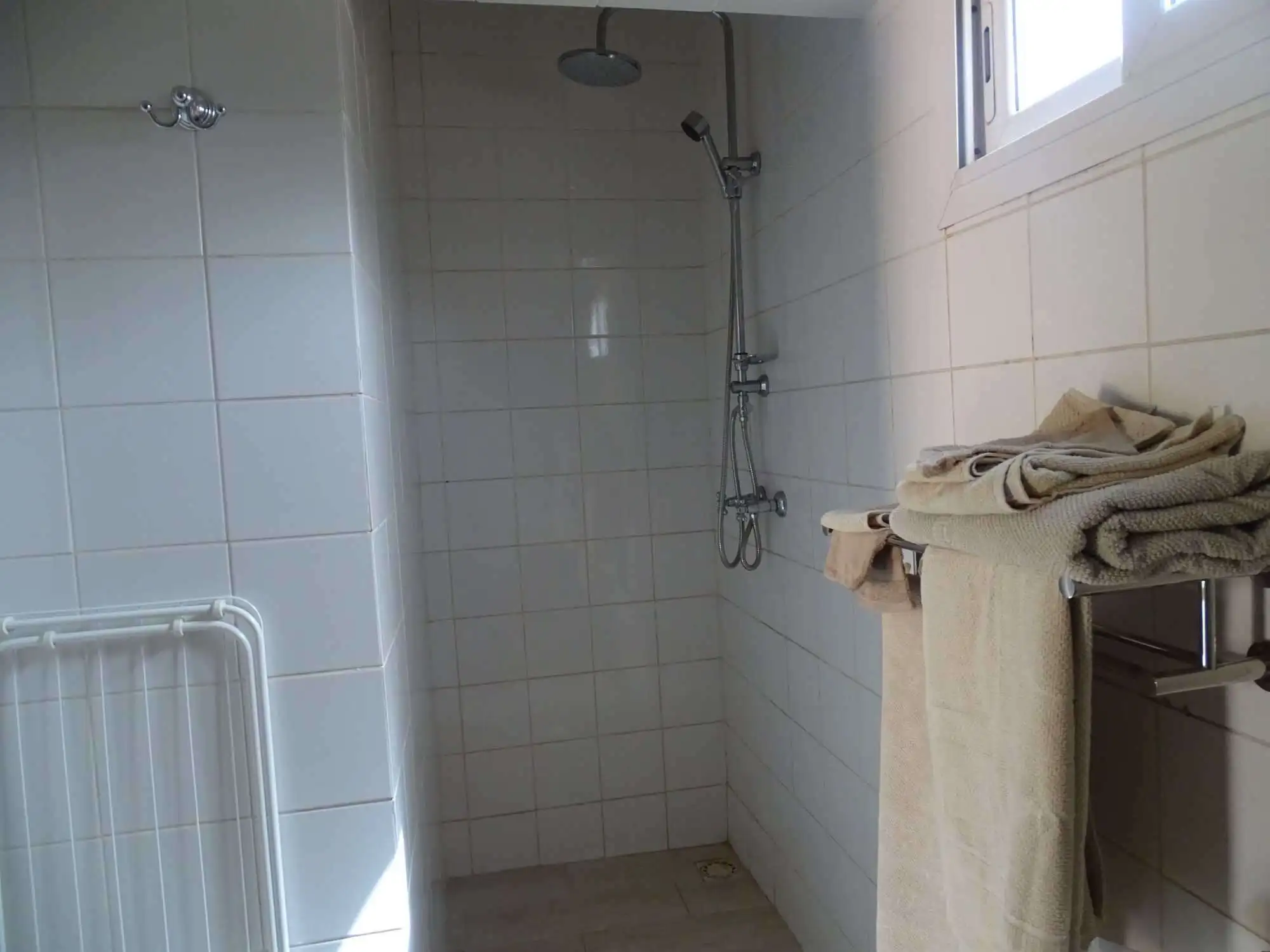 Modern bathroom with shower in Kombo North district property.