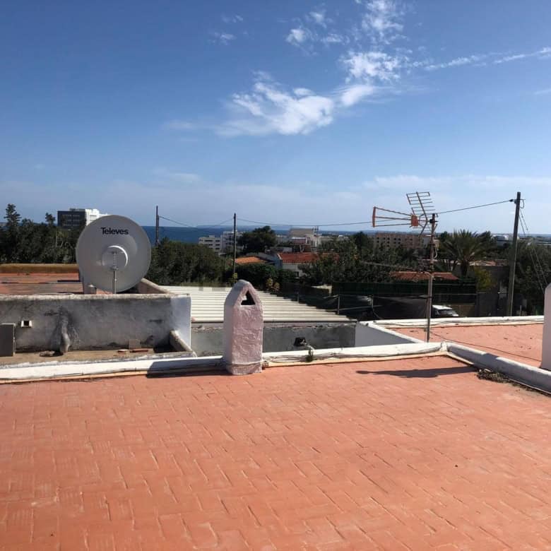 Villa estate with two houses for sale in Playa Den Bossa, Ibiza, featuring rooftop views and outdoor.