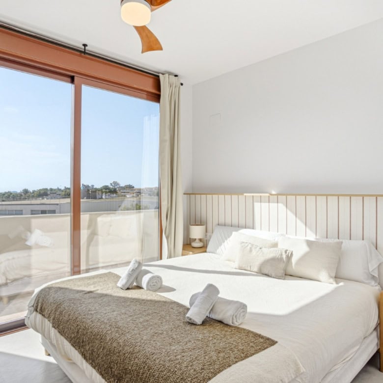 Elegant bedroom with large window and balcony view in Cancelada, Estepona.