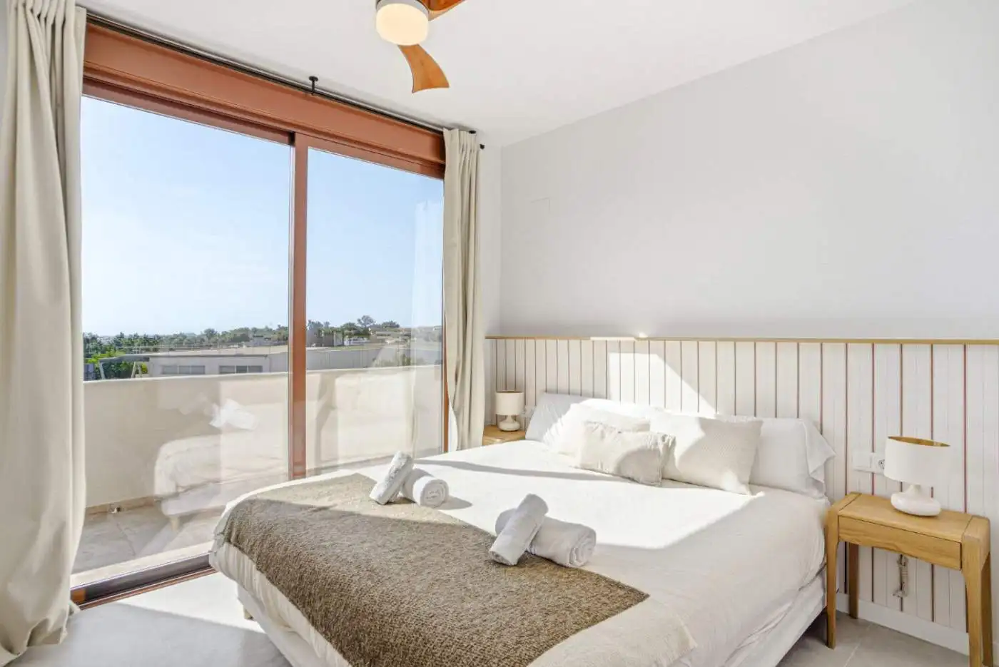 Elegant bedroom with large window and balcony view in Cancelada, Estepona.