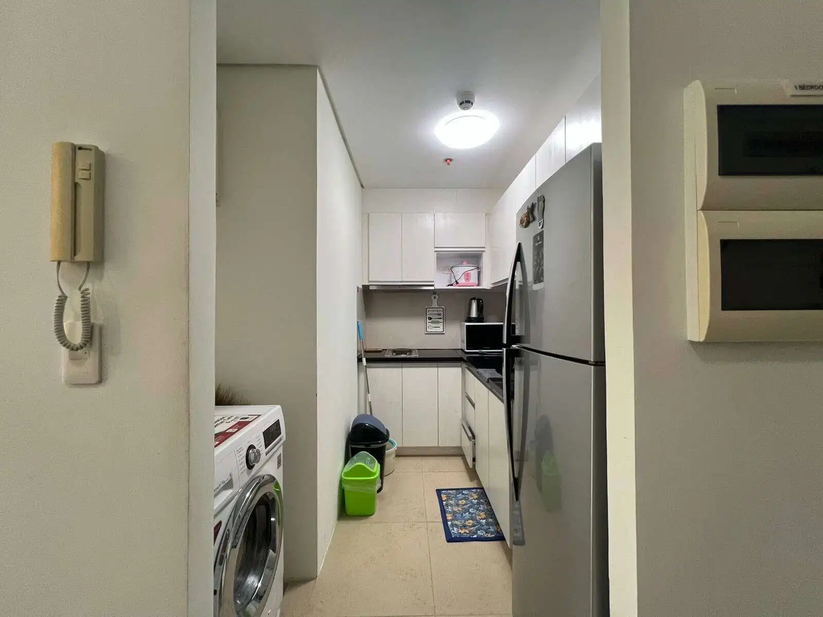 Modern kitchen with white cabinets and stainless steel appliances in Oceanway Residencies Boracay.