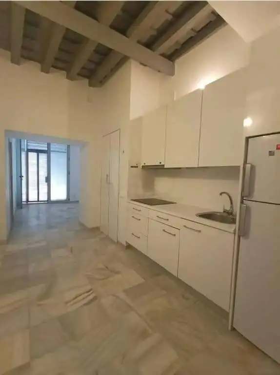 Bright and spacious kitchen with white cabinetry and stainless steel appliances in El Puerto de Sant.