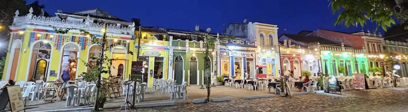 Colorful colonial houses in Canavieiras, Bahia, Brazil illuminated at night.