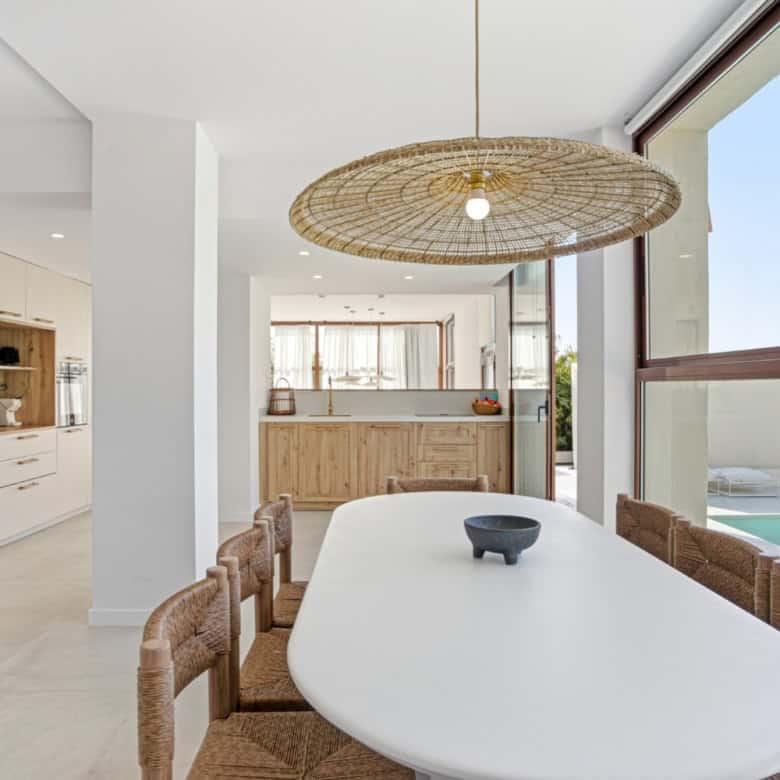 Bright dining space with large windows and ocean views in Estepona.