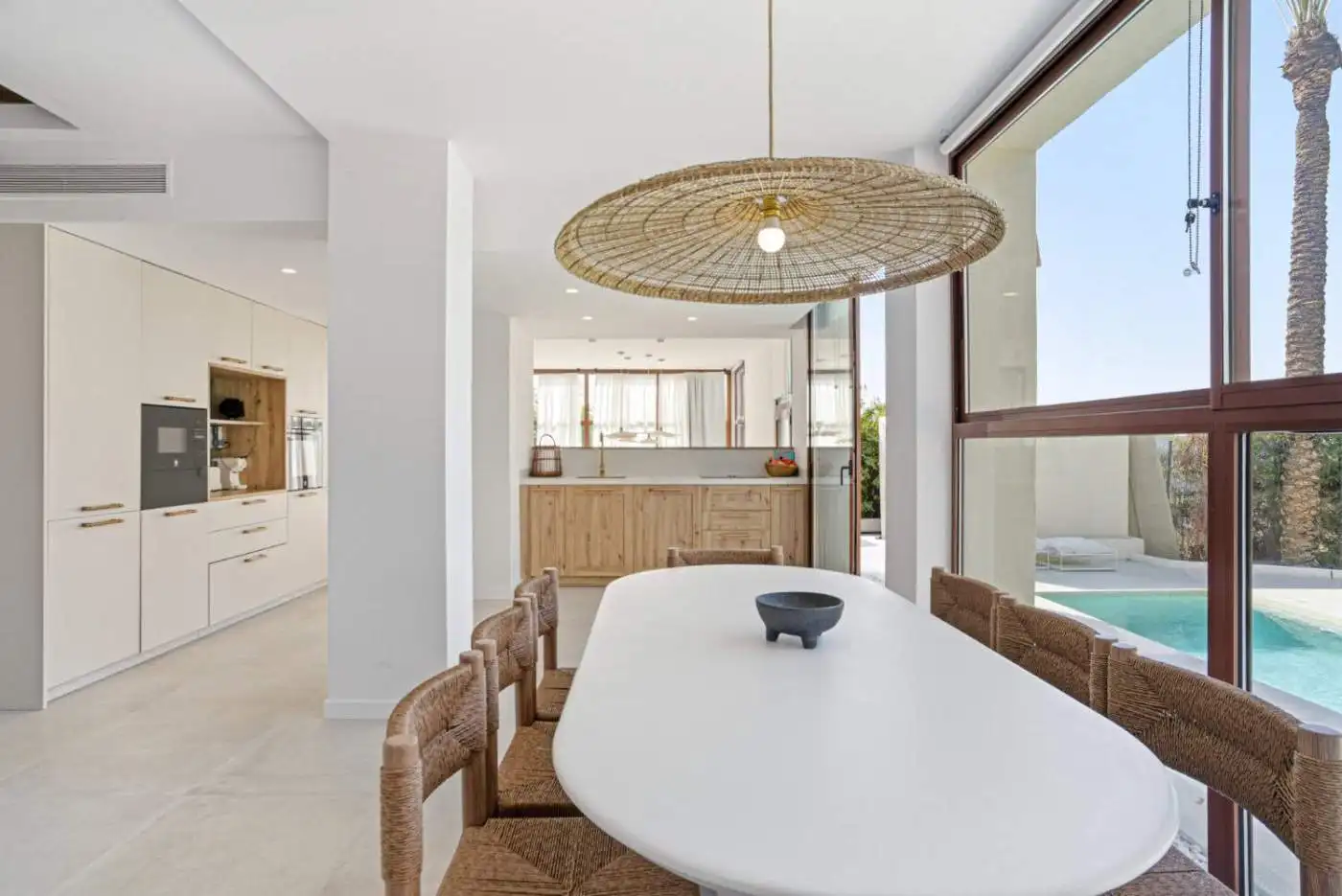 Bright dining space with large windows and ocean views in Estepona.