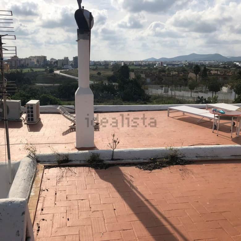 Rooftop terrace of villa estate with outdoor seating and city views in Playa Den Bossa, Ibiza, Spain.