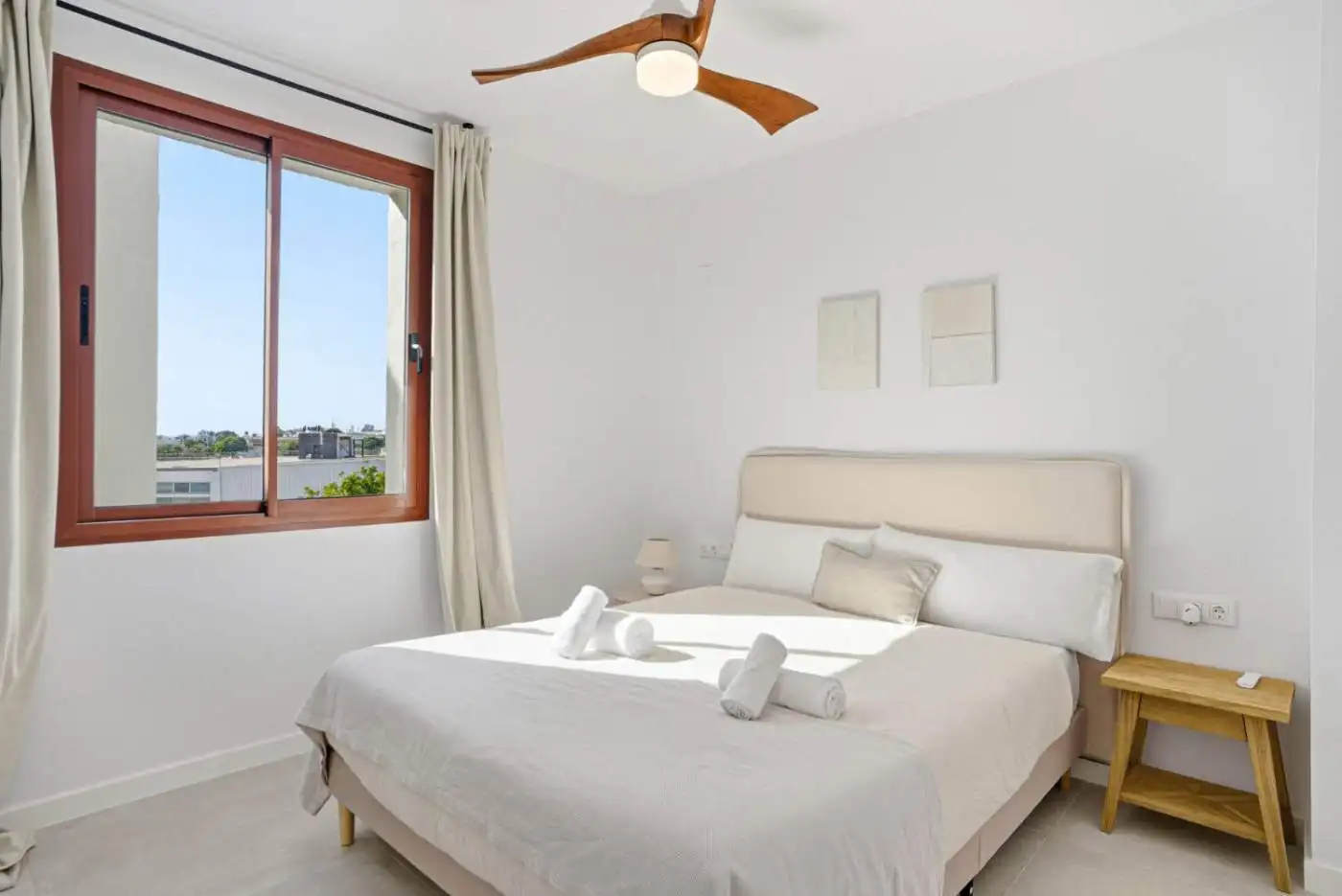 Elegant bedroom with large window and modern decor in Cancelada, Estepona.
