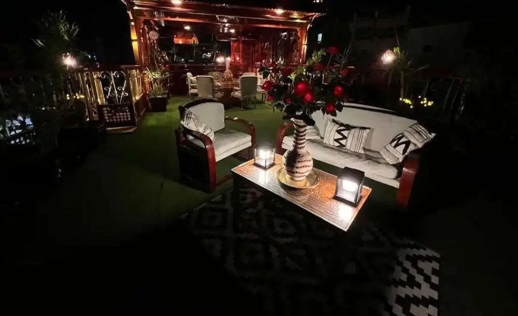 Outdoor lounge with cozy seating and ambient lighting in Derrymore Glen Estate.