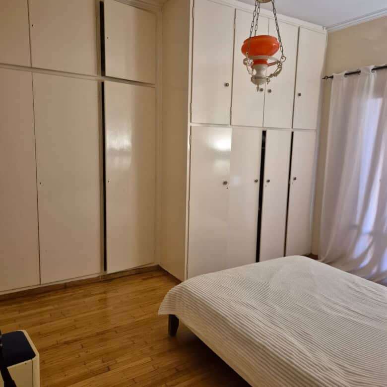 Spacious bedroom with built-in wardrobes and natural light.