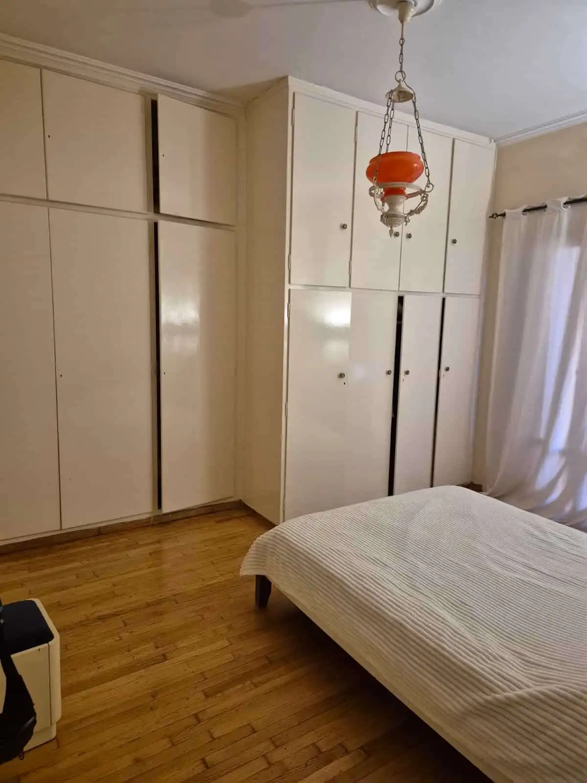 Spacious bedroom with built-in wardrobes and natural light.